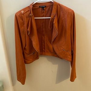 this is a orange jacket with gold zippers the size is medium the brand is MICHEL